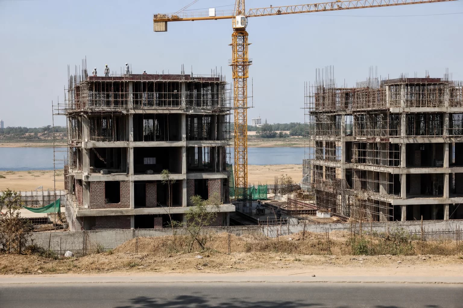 Towers under construction near the river in Koba